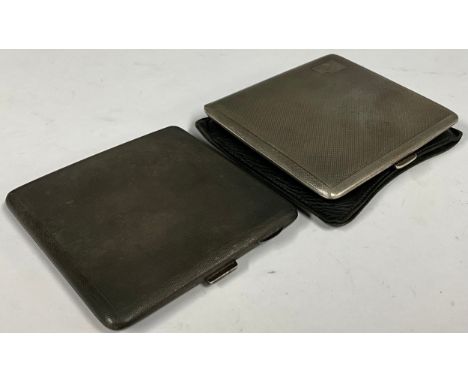 An Edward VII silver cigarette case, Birmingham 1934, another Birmingham 1955, both with engine turned exterior, gilt interio
