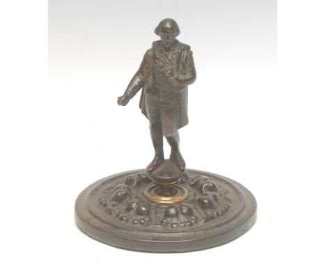 A 19th century patinated bronze desk weight, as William Shakespeare holding a manuscript, mounted on a bronze roundel decorat