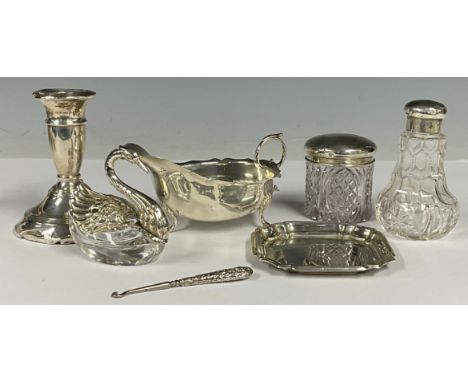 A George V silver cream jug, Birmingham 1910; a 925 silver mounted novelty inkwell, as a swan; other silver including candles