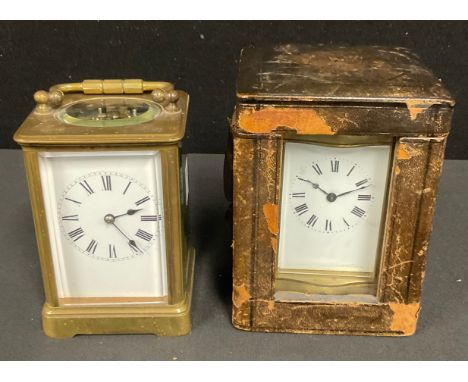 An early 20th century French lacquered brass carriage timepiece, Roman numerals on white enamel dial, 12cm high excluding han