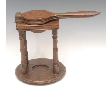 Treen - a Victorian oak lemon squeezer on stand, brass hinges, turned legs, circular base, 25cm high overall, stamp to base, 