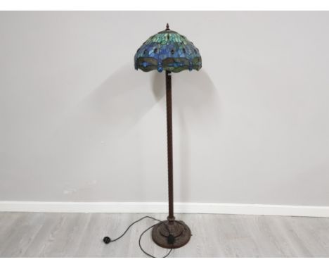 A metal Tiffany style standard lamp with dragonfly decoration shade 160cm high.