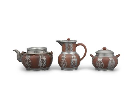 A PEWTER-OVERLAID THREE-PIECE (3) YIXING TERRACOTTA TEASET  CHINA, 20TH CENTURY It consists of: - one lidded teapot; - one li
