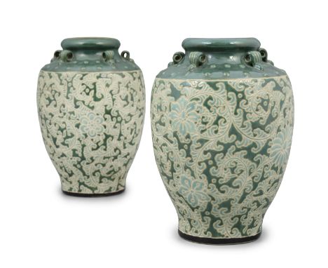 A PAIR BIEN HOA 边和 STONEWARE ‘LOTUS’ JARS VIETNAM, BIEN HOA SCHOOL OF APPLIED ARTS, 20TH CENTURY Resting on waisted feet, wit