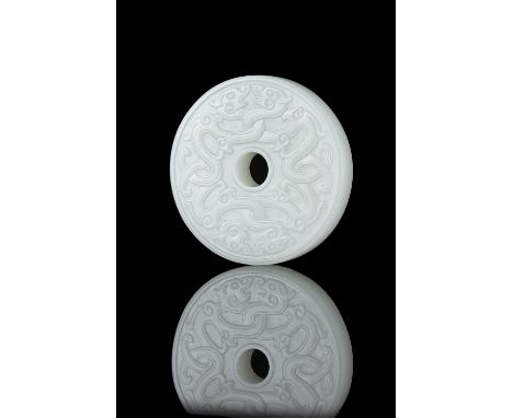 A WHITE JADE ‘KUI DRAGONS’ BI DISC / PENDANT  CHINA, 20TH CENTURY  D: 5,3 cm Gross weight: 53,3 grams   白玉夔龙吊坠 中国，20世纪  NOTE: