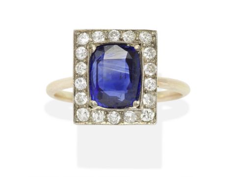 SAPPHIRE AND DIAMOND PLAQUE RING, CIRCA 1900The cushion-shaped sapphire, within a surround of old brilliant-cut diamonds, sap