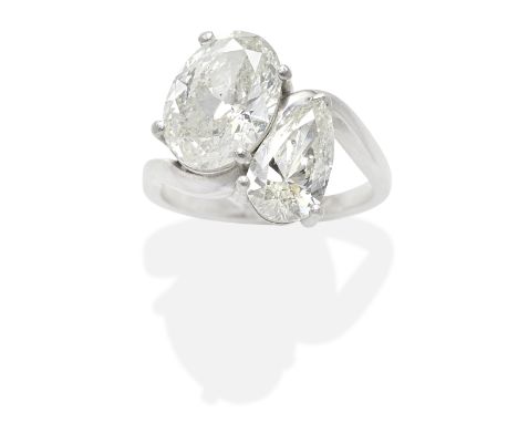 DIAMOND TWO-STONE RINGSet with a pear-shaped diamond weighing 1.20 carats and an oval-cut diamond weighing 2.51 carats, mount
