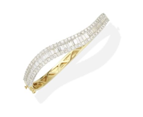 DIAMOND BANGLEHinged, set with brilliant and baguette-cut diamonds, diamonds approx. 5.05cts total, inner circumference appro