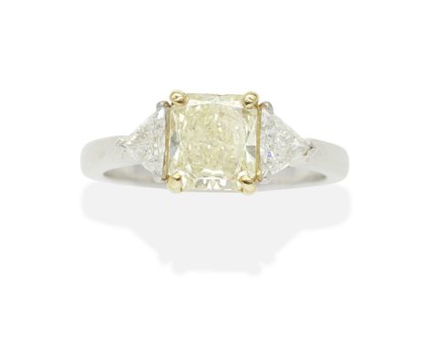 FANCY YELLOW DIAMOND AND DIAMOND RINGThe cut-cornered rectangular modified brilliant cut Fancy Light Yellow diamond weighing 