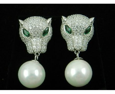 A pair of silver and cubic zirconia and faux pearl panther drop earrings. 