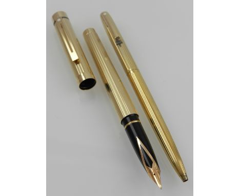 A Sheaffer gold plated fountain pen, of reeded design, nib stamped 14K, together with a Sheaffer gold plated ballpoint pen.