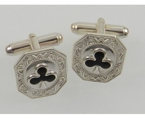 A pair of silver and enamel cuff links, decorated with shamrocks.