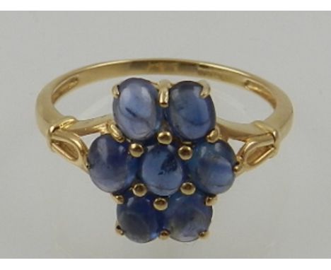 A 9 carat yellow gold and cabouchon sapphire floral cluster ring. 