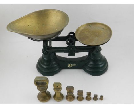 A set of cast metal scales, together with brass weights. 