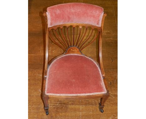 An Edwardian rosewood and upholstered low seat chair, the pad rail back above a fan splat with foliate inlay, on square taper