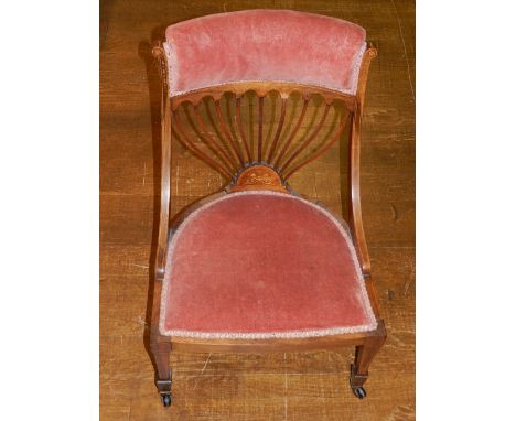 An Edwardian rosewood and upholstered low seat chair, the pad rail back above a fan splat with foliate inlay, on square taper