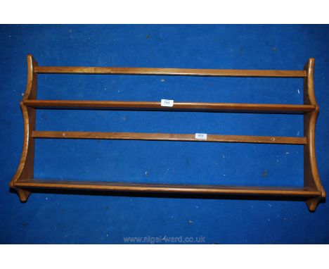 An Ercol wall hanging plate rack, 38" x 20".