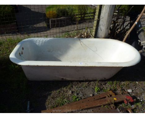 A cast white enamel roll top bath.