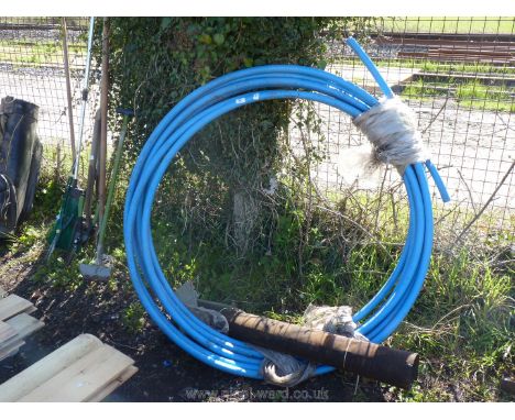 A coil of 32 mm water pipe and a small roll of mineral felt.
