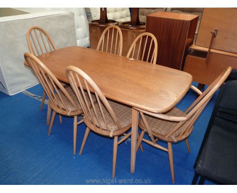 An Ercol "Golden Dawn" dining table (60" x 30") with four matching chairs and two carvers.