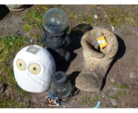 A concrete boot garden planter and light garden features.