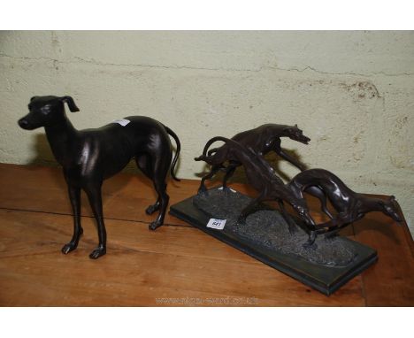 A modern heavy cast model of a Greyhound 12" tall and a resin model of a group of running Greyhounds, 18" long x 9 1/2" wide.