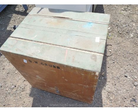 A wooden tool/storage box with uplifting sides.