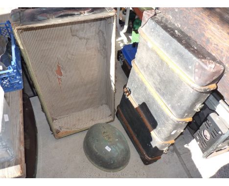 A large steamer trunk (A/F) and a metal serving dish lid.