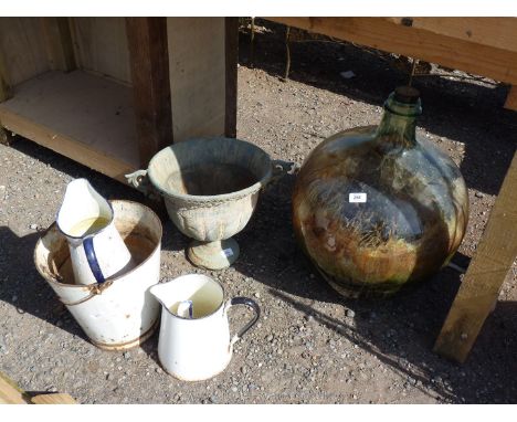 A large glass carboy, enamel ware and metal urn.