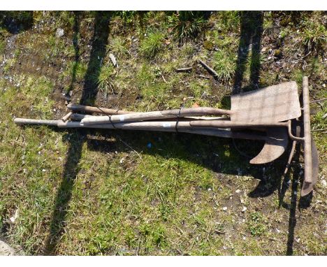 A bundle of rakes, spades, edging tools, hook etc.