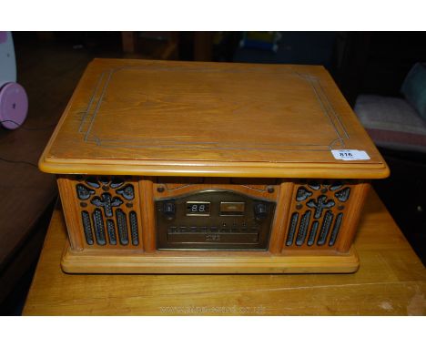 A wooden cased record player, CD, radio combination unit.