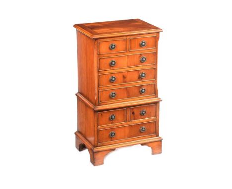 SATINWOOD MINIATURE CHEST OF DRAWERS FITTED WITH FOUR SHORT AND FOUR LONG DRAWERS WITH DROP RING HANDLES.RAISED ON BRACKET FE