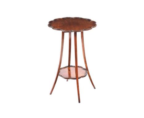 MAHOGANY LAMP TABLE WITH SCALLOPED TOP AND UNDERSHELF. RAISED ON THREE SPLAYED LEGS.HEIGHT: 28 INCHES.DIAMETER: 18 INCHES.IN 