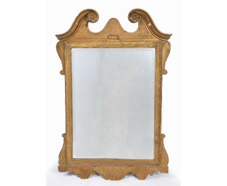 A Georgian carved giltwood rectangular wall mirror with a scrolling break arch pediment and bevelled glass, 71cm wide x 110cm