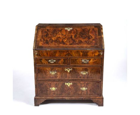 George I burr walnut veneered bureau, the fall front opening to reveal short drawers and pigeon holes above two short and two