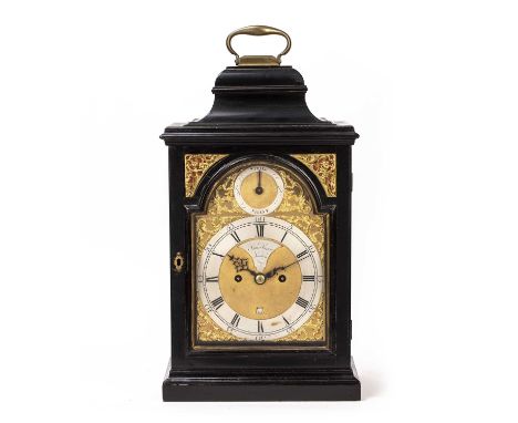 An 18th century ebonised bracket clock, Samuel Swain, London. Surmounted by a brass handle, fish scale fret and glazed sides,