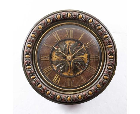 A late 19th century oak dial clock with applied brass Roman chapters, leaf carved and polychrome decorated centre, egg and da