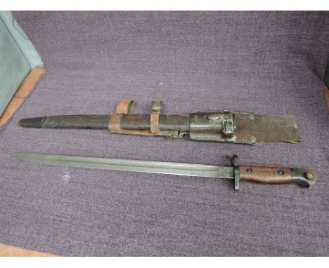 A British 1907 Bayonet by Wilkinson with various proof marks on blade, leather scabbard and frog, blade length 43.5cm, overal