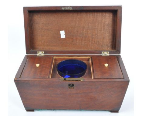 A vintage 20th century mahogany tea caddy. In sarcophagus form with brass plate to top, hinged lid opening to reveal central 