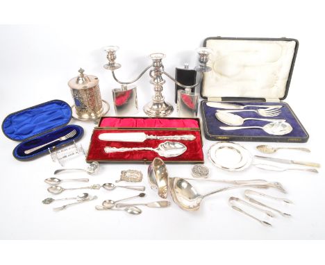 A collection of 19th and 20th Century silver plated items to include candlestick, hip flasks, ladles, boxed serving cutlery, 