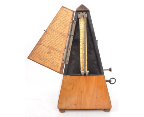 A mid century 1950's walnut veneer clockwork&nbsp;metronome. Brass plates reads "M&eacute;tronome&nbsp;De Maelzel Angleterre 