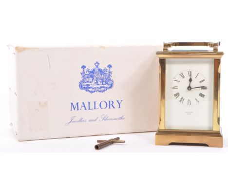 A vintage later 20th century mantel clock of rectangular form having a white dial with Roman numeral chapter ring and faceted