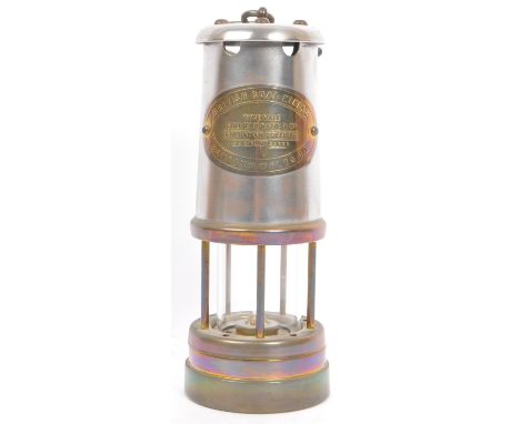 A vintage 'British Coal Mining Company Wales UK', brass and steel paraffin oil lamp with hanging hook. The brass name plate s