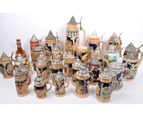 A large collection of 20th Century ceramic German beer steins in varying sizes with polychrome painted decoration depicting G