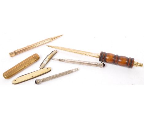 A collection of vintage 20th century desktop stationery items. Including cabochon top white metal pencils, wooden turned page