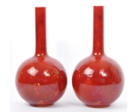 A pair of early 20th century&nbsp;Burmantofts ceramic tin glazed globular vases. Each vase having a straight elongated neck o