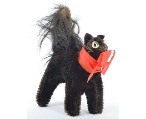 A mid century 1960's soft toy teddy bear 'Halloween Cat' by Steiff, Germany. A black mohair cat with red ribbon, in startled 