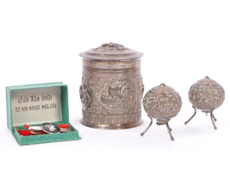 A vintage Burmese Sterling silver lidded pot together with a matching pair of white metal salt and pepper shakers. The lidded