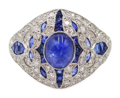 Platinum (tested) ring set with a central cabochon sapphire and calibre cut sapphires and diamond surround
