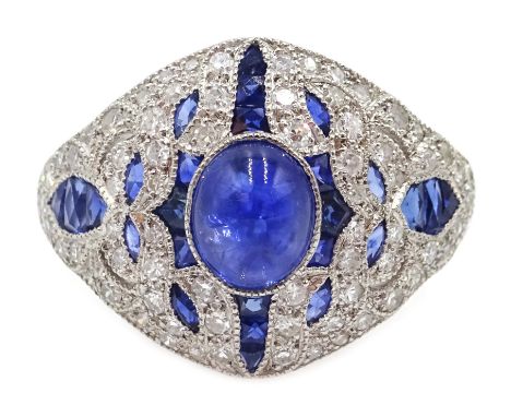 Platinum (tested) ring set with a central cabochon sapphire and calibre cut sapphires and diamond surround